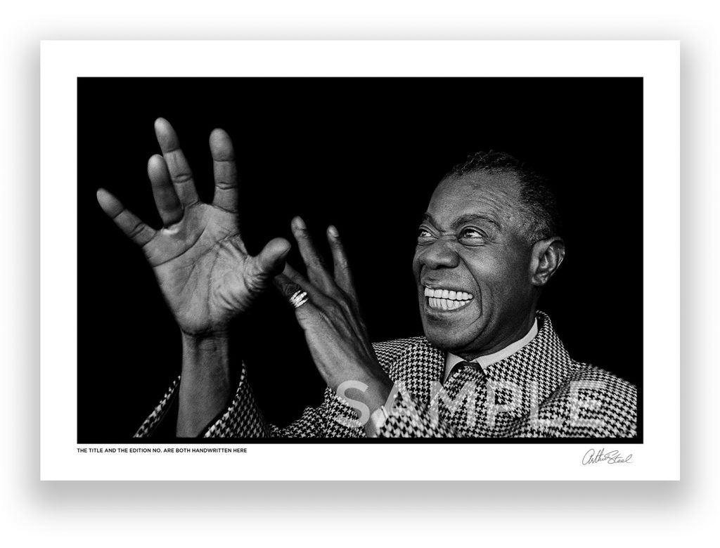 an exclusive black and white photograph of the famous american jazz musician louis armstrong air playing the trumpet by british photojournalist arthur steel