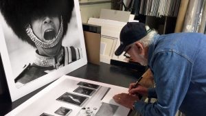 photographer arthur steel signing a photograph