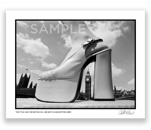 an exclusive black and white photograph of a platform shoe arching over big ben by arthur steel