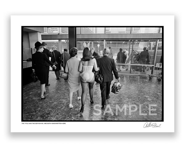 an exclusive black and white photograph of a british playboy bunny at london heathrow airport by arthur steel