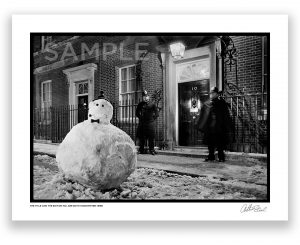 an exclusive black and white photograph of a snowman outside at number ten downing street flanked by two policemen london by british photojournalist arthur steel